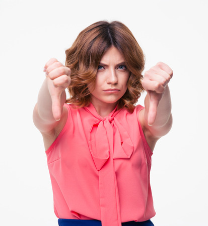 Casual woman showing thumb down sign isolated on a white background. Looking at cameraの写真素材