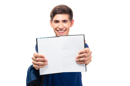 Male student showing blank opened book isolated on a white background. Looking at camera. Focus on bookの写真素材