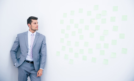 Businessman leaning on the wall and looking on stickersの写真素材