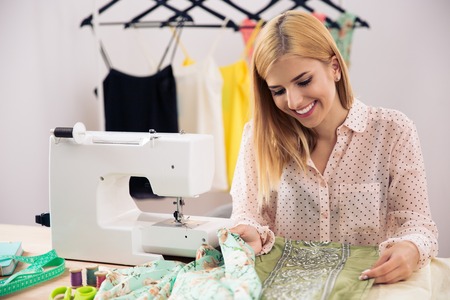 Happy female designer working in workshopの写真素材