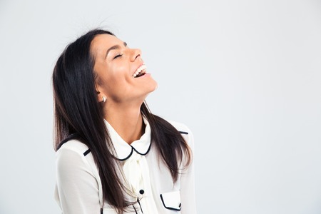 Portrait of a happy young woman laughing isolated on a white backgroundの写真素材