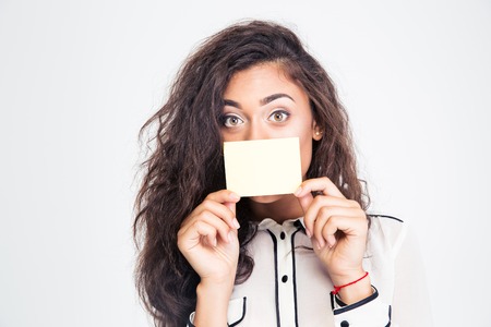 Businesswoman covering her mouth with blank card isolated on a white backgroundの写真素材