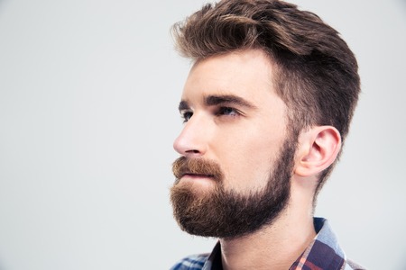 Closeup portrait of a pensive man looking up isolated on a white backgroundの写真素材