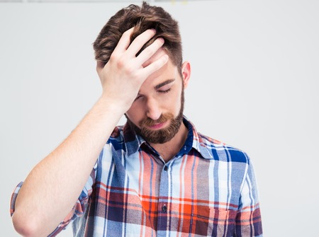 Portrait of frustrated man standing isolated on a white backgroundの写真素材
