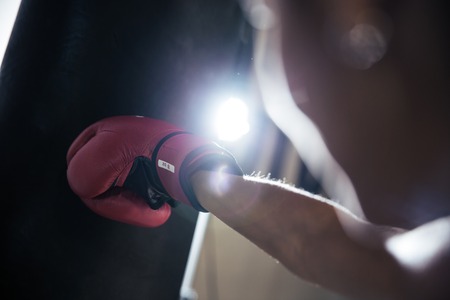 Closeup portrait of a female hand in boxing glove
