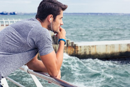 Side view portrait of a sports man looking at sea ourdoorsの写真素材