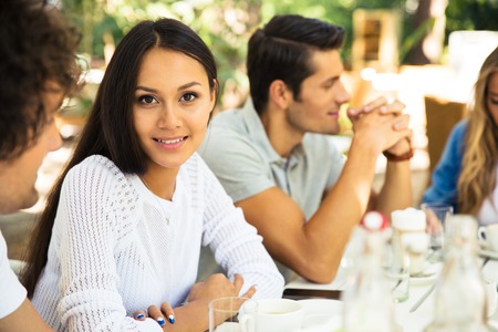 Happy friends enjoying meal in outdoor restaurantの写真素材