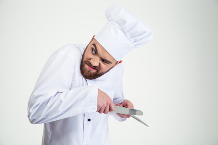 Portrait of a male chef cook sharpening knife isolated on a white background
