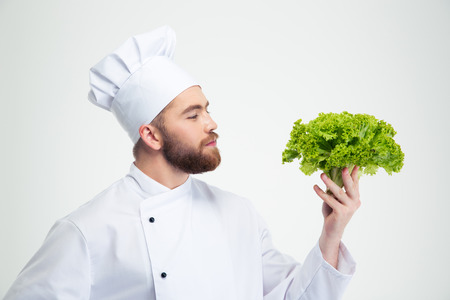 Portrait of a handsome male chef cook holding salad isolated on a white backgroundの写真素材