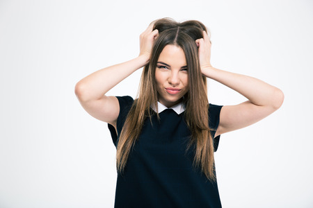 Portrait of a cute woman touching her hair isolated on a white backgroundの写真素材