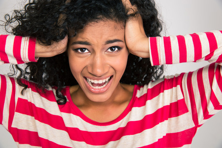 Portrait of afro american woman shouting isolated on a white backgroundの写真素材