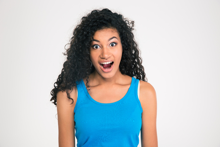 Pportrait of a shocked afro american woman looking at camera isolated on a white backgroundの写真素材