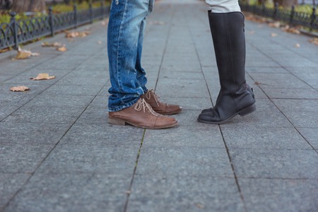 Closeup portrait of a man`s and woman`s legs during a dateの写真素材