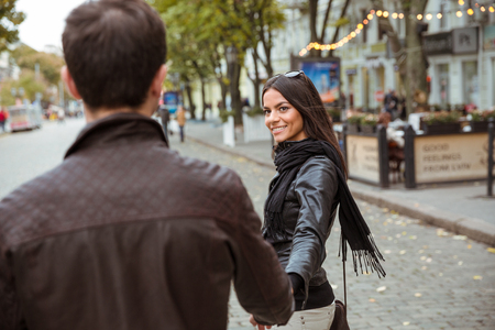 Happy young couple walking outdoors in old townの写真素材
