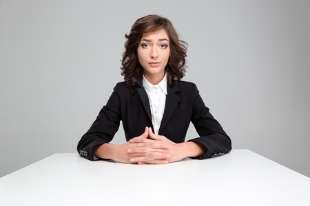 Portrait of sad disspointed pretty curly woman in black jacketの写真素材