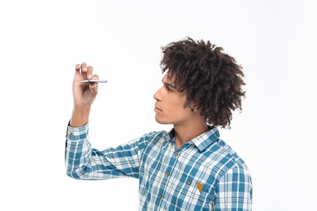 Portrait of a young afro american man looking on slim smartphone isolated on a white background