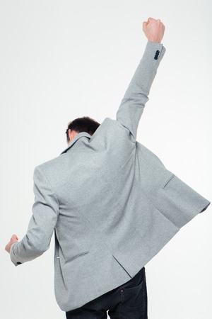 Back view portrait of a businessman celebrating his success isolated on a white backgroundの写真素材