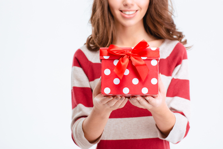 Cropped image of a happy woman holding gift box isolated on a white backgroundの写真素材