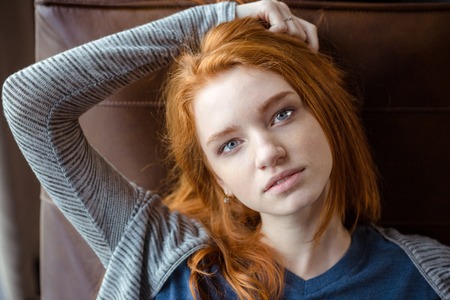 Portrait of a beautiful redhead woman looking at cameraの写真素材