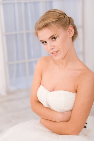 Portrait of a happy bride in white wedding dress looking at cameraの写真素材