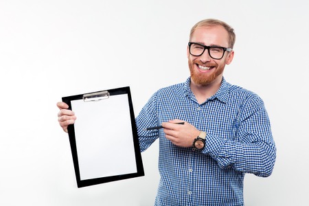 Portrait of a cheerful man showing blank clipboard isolated on a white backgroundの写真素材