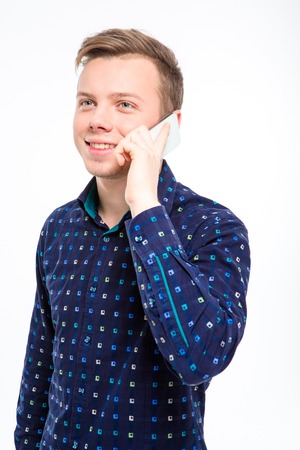Portrait of a smiling man talking on the phone isolated on a white backgroundの写真素材