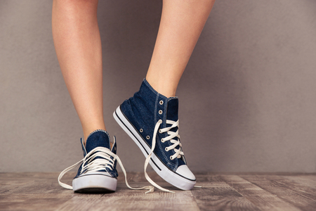 Closeup portrait of a human legs in sneakersの写真素材