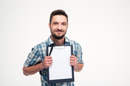 Happy smiling bearded man in checkered shirt holding blank clipboard over white backgroundの写真素材