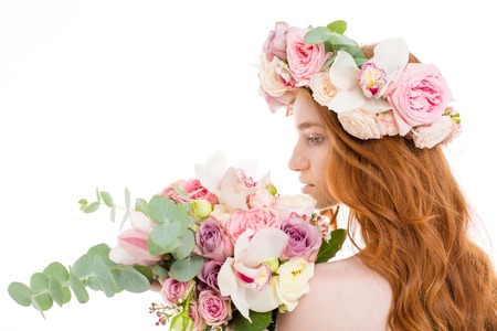 Back view portrait of a redhead woman standing with flowers isolated on a white backgroundの写真素材