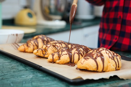 Closeup of fresh homemade croissants with chocolate on tray