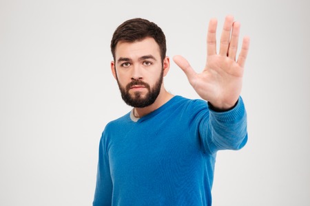 Man showing stop sign with palm isolated on a white background