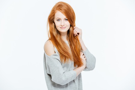 Beautiful redhead woman looking at camera isolated on a white background