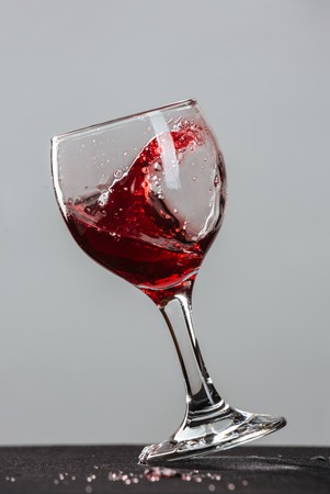 Red wine splash on gray backgroundの写真素材