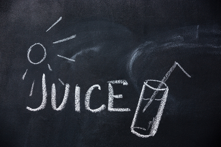 Juice and sun drawn on blackboard by chalkの写真素材