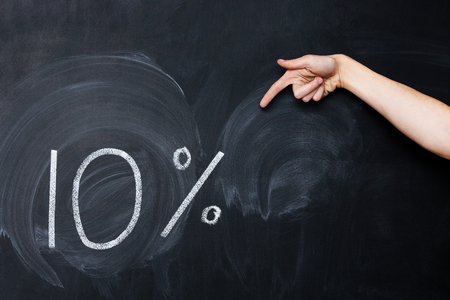 Hand pointing on ten percent drawn on blackboard with chalk