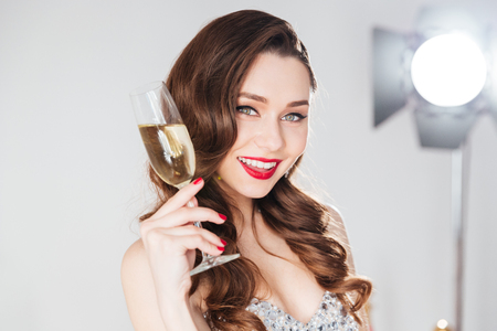 Happy attractive woman holding glass of champagneの写真素材