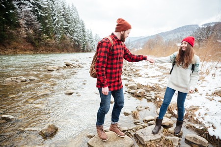 Happy couple traveling on the river in forestの写真素材
