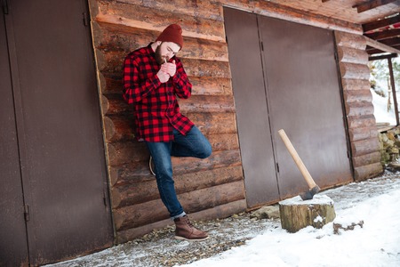 Full length portrait of a man smoking outdoorsの写真素材