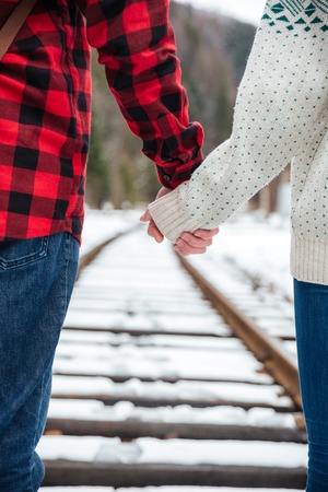 Cropped image of couple walking on railwayの写真素材