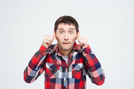 Man making a silly monkey face isolated on a white background