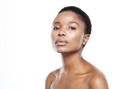 Beauty portrait of afro american woman with fresh skin looking at camera isolated on a white backgroundの写真素材