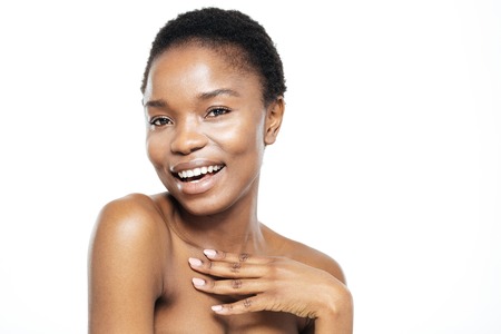 Beauty portrait of a happy afro american woman looking at camera isolated on a white backgroundの写真素材