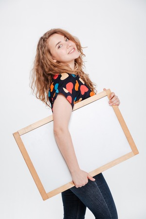 Happy woman holding blank board isolated on a white backgroundの写真素材