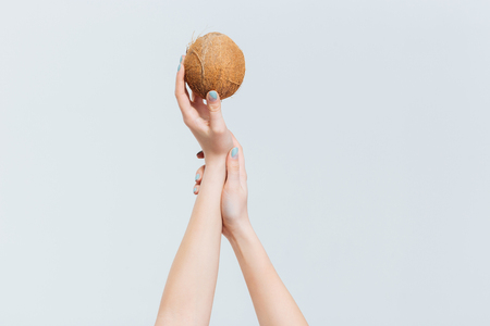 Female hands coconut isolated on a white backgroundの写真素材