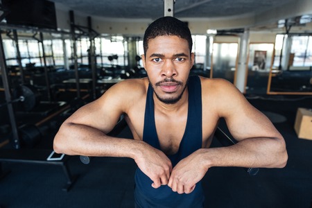 Fitness afro american man resting in the gym after workout and lookind at cameraの写真素材