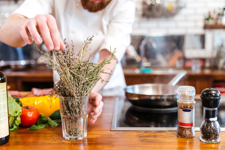 Cropped image of a chef cook preparing food in the kitchenの写真素材