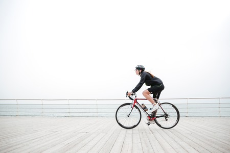 Woman riding on a bicycle outdoorsの写真素材