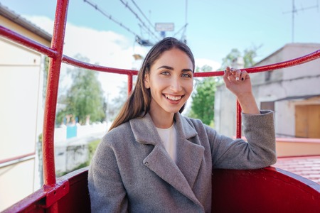 Portrait of a pretty young cheerful girl having fun outdoorsの写真素材