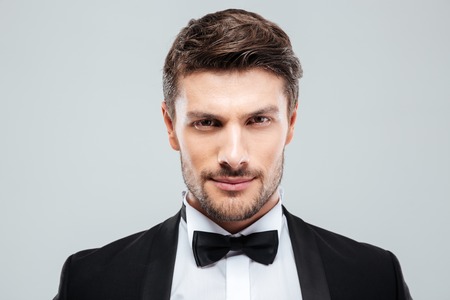 Closeup of attractive confident young man in tuxedo with bowtieの写真素材