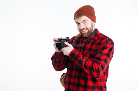 Smiling man making photo on camera isolated on a white backgroundの写真素材